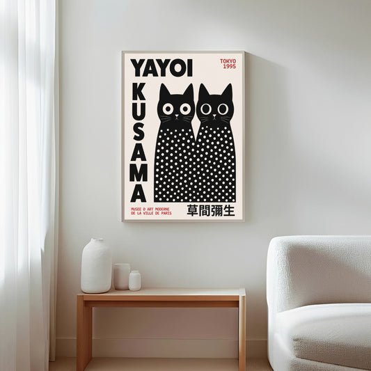Framed Yayoi Kusama cats artwork with black and white polka dots on a wall in a living room.
