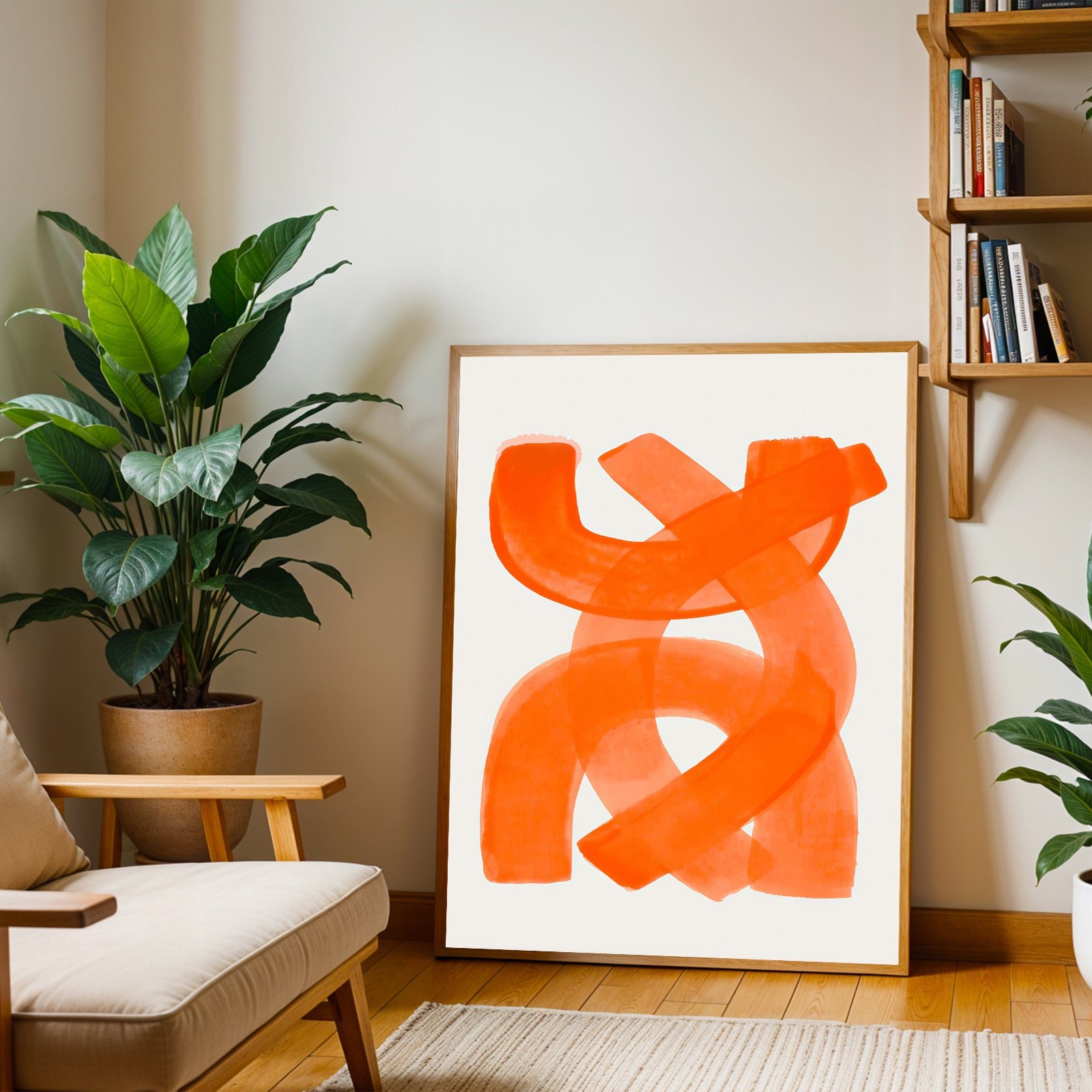 Living room with abstract orange artwork on a white wall, plant, and bookshelf.