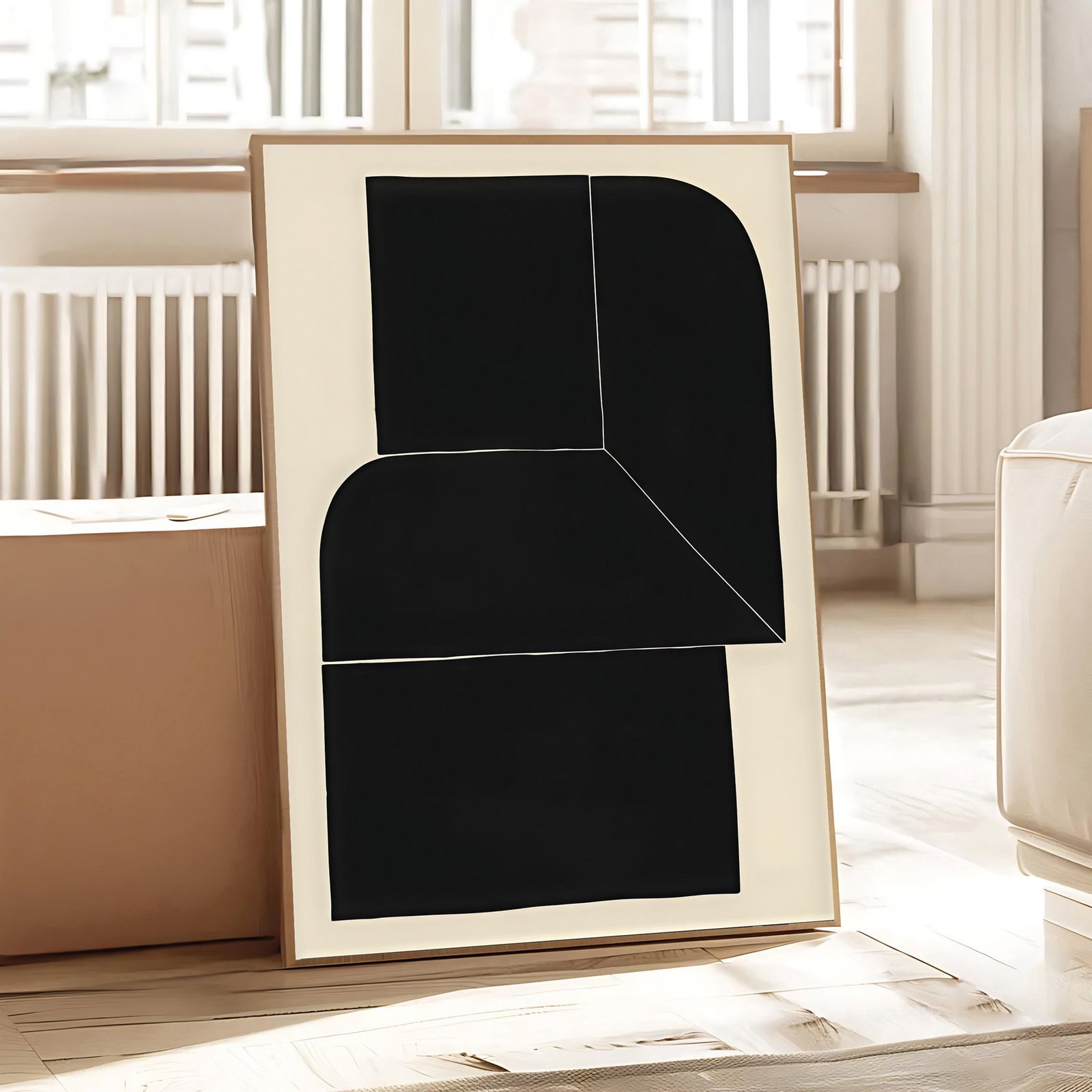 Black abstract art piece leaning against a wall in a room with large windows.