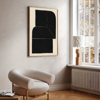 Modern interior with a black abstract painting on a white wall, a beige armchair, and a window with a view of trees.