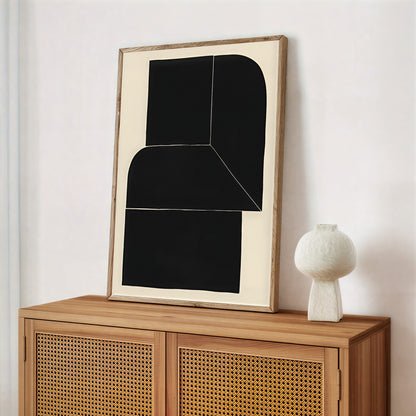 Abstract art piece on a wooden cabinet with a white vase.